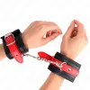 KINK - WRIST RESTRAINTS BLACK WITH RED BELT ADJUSTABLE 17-28 CM X 6 CM